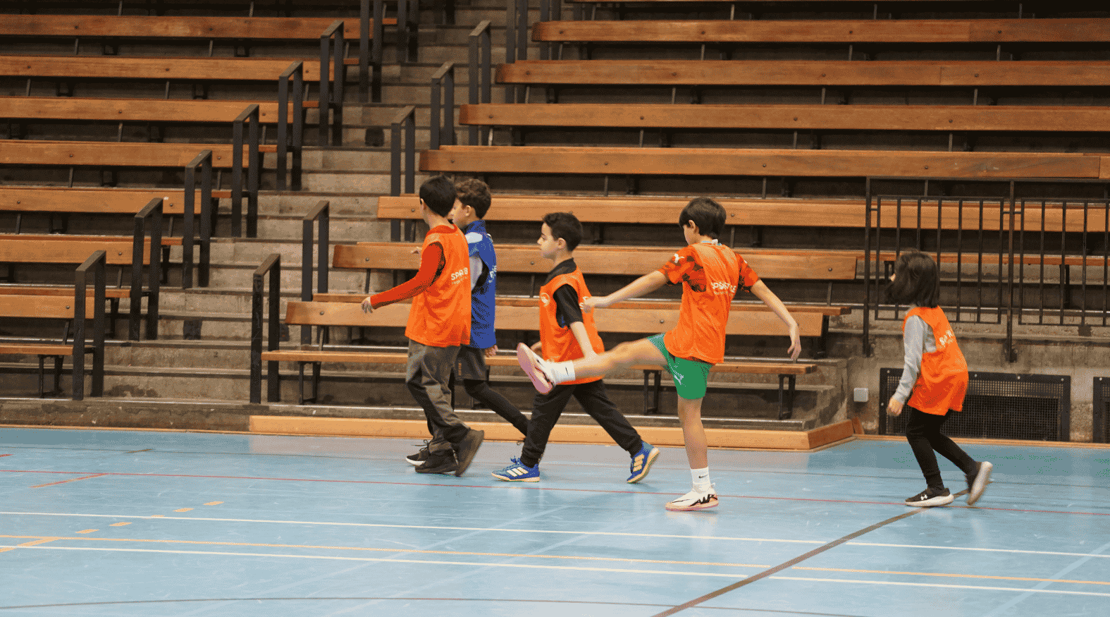 Jongeren met een Sport2Be hesje op een sportveld